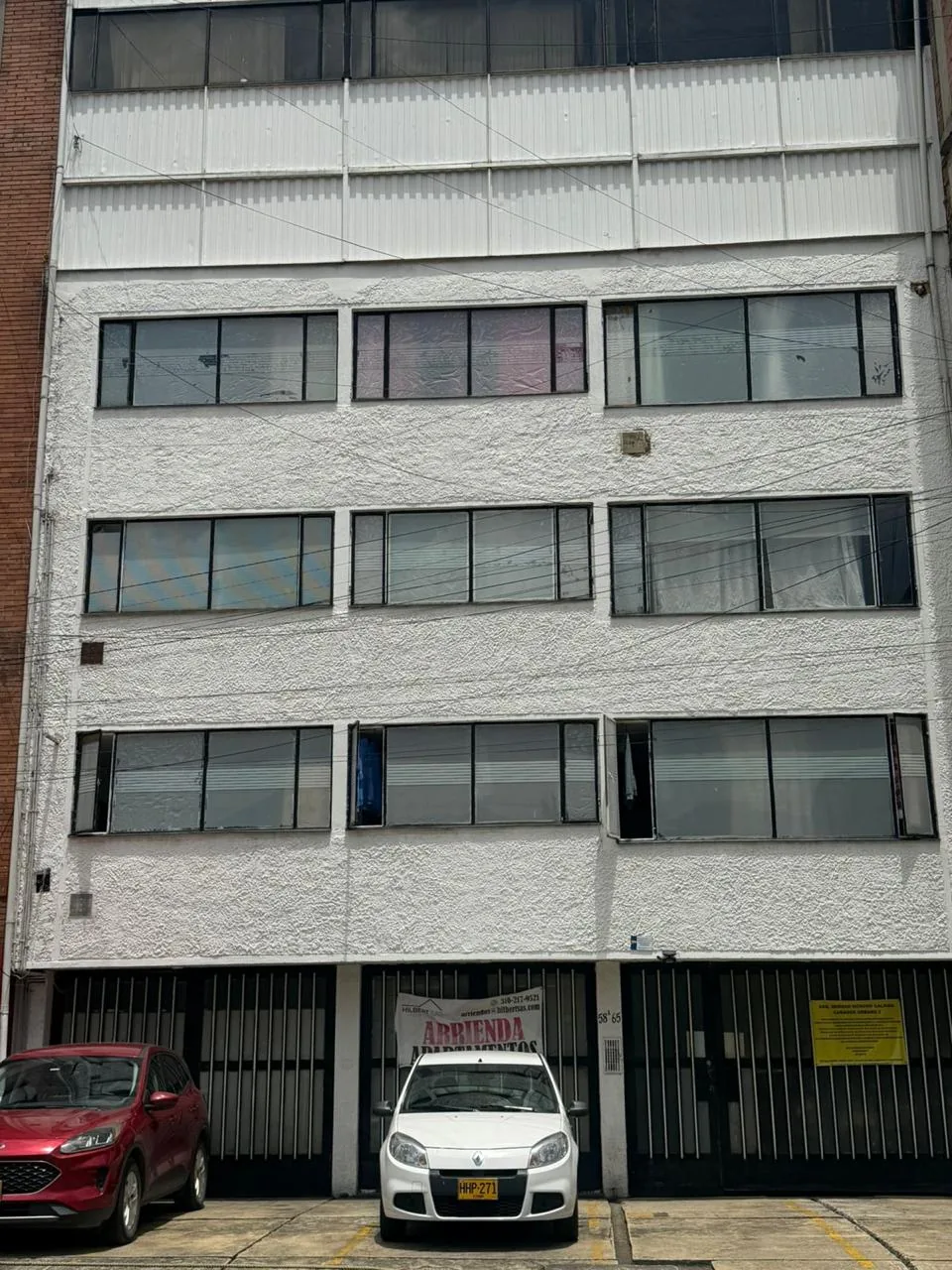 Edificación de fachada blanca con accesos en planta baja